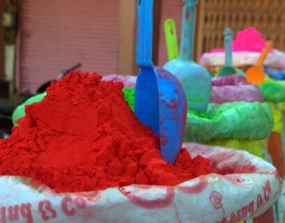 blue plastic toy on pink and white floral textile