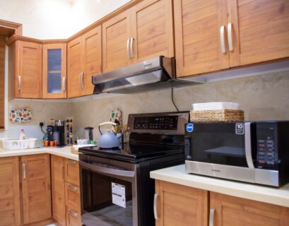 white microwave oven on brown wooden kitchen cabinet