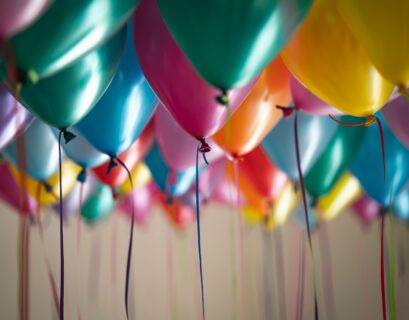 selective focus photography of assorted-color balloons