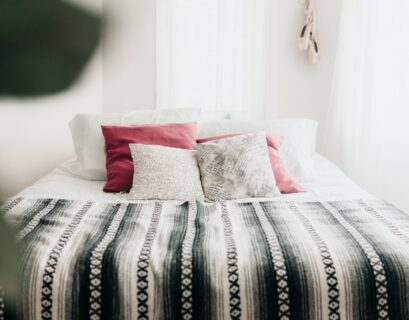 bed with throw pillows and blanket