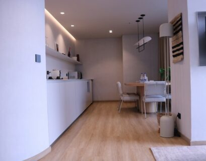 a room with a table, chairs and a television