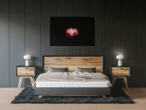 a bedroom with a bed, nightstands and a painting on the wall